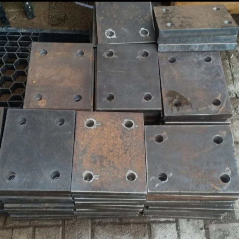 Heavy-duty scaffolding base plate stock at an industrial construction manufacturing site